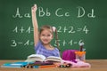 Little girl in the school, and behind the plate letters Royalty Free Stock Photo