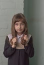 Little girl schoolgirl stands. Child 9 years old schoolgirl in a school dress with brown hair Royalty Free Stock Photo