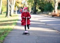 Little girl on a scooter