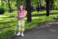 Little girl with scooter in park Royalty Free Stock Photo