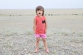 Little girl screaming in big landscape environment. Child emotionally saying loudly, singing a song with expression