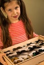 Little Girl Scrutinizes Entomology Collection of Tropical Butterflies Royalty Free Stock Photo