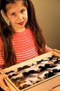 Little Girl Scrutinizes Entomology Collection of Tropical Butterflies Royalty Free Stock Photo