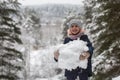 Little girl sculpts snowman in the winter Park. Royalty Free Stock Photo