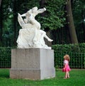 Little girl and sculpture