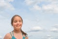 Little girl on the sea against a blue sky and clouds. Copy space Royalty Free Stock Photo