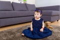Little girl seating on carpet