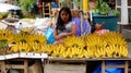 Little girl selling banana at the market