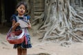 A little girl selling her post card