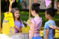 Little girl selling natural lemonade to kids. Summer refreshing drink Royalty Free Stock Photo