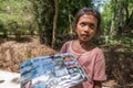Little girl selling pictures in Laos