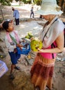 Little girl is selling souvenirs to female tourist in Angkor Wat