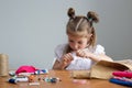 little girl sewing things by herself Royalty Free Stock Photo