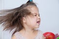Little girl shakes head splashing hair. funny child with expressive emotion dancing Royalty Free Stock Photo