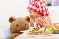 Little girl sharing secrets with her teddy bear Royalty Free Stock Photo