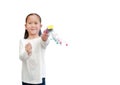 Little girl shooting party popper confetti over white background with copy space. Focus at kid hand