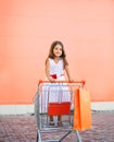 Little girl in shopping cart outdoors Royalty Free Stock Photo