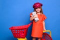 Little girl on shopping. Sale. Cute kid with many dollars shopping bags. Portrait of a daughter in dressshoes near Royalty Free Stock Photo