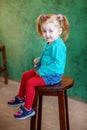 The little girl in shorts sitting on a chair. The concept of chi Royalty Free Stock Photo