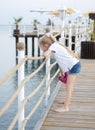 Little girl on the pier by the sea Royalty Free Stock Photo