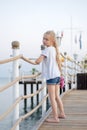 Little girl on the pier by the sea Royalty Free Stock Photo