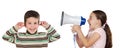 Little girl shouting through megaphone at a boy Royalty Free Stock Photo