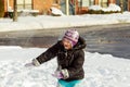 Little girl shoveling snow on home drive way. Beautiful snowy garden or front yard. Royalty Free Stock Photo