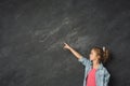 Little girl showing finger up at gray background Royalty Free Stock Photo