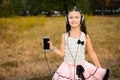 Little girl showing her mobile telephone and smiling