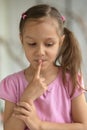 Little girl showing hush sign