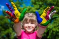 Little girl showing painted hands, focus on hands. Hand prints Royalty Free Stock Photo