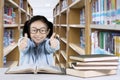 Little girl showing thumbs up in the library Royalty Free Stock Photo