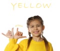 Little girl showing word YELLOW on white. Sign language