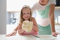 Little girl shows the dough and smiles Royalty Free Stock Photo