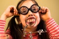 Little Girl Shows her teeth in Magnifier. Child Scientist