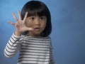 Little girl shows number five finger gesture Royalty Free Stock Photo