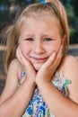 A little girl shows a wobbly baby tooth in her mouth