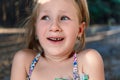 A little girl shows a wobbly baby tooth in her mouth