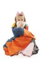 Little girl sick blowing her nose with tissue and cover with blanket sitting on floor Royalty Free Stock Photo