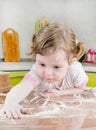 Little girl sifts flour