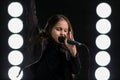 Little girl singing in front of stage lights Royalty Free Stock Photo