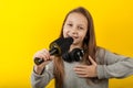 Little girl sings into a microphone on a yellow background. Karaoke for children Royalty Free Stock Photo