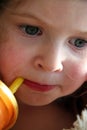 Little girl sipping from a straw