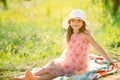 Little girl sit on green grass in summer park. Outdoor portrait of funny kids face. Summer kid outdoor portrait. Kid Royalty Free Stock Photo