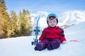 Little girl sit on snow with mountain ski in sport outfit Royalty Free Stock Photo