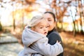 Little girl sits in her mother arms and looks away