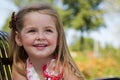 A little girl sits on a park bench Royalty Free Stock Photo