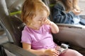 The little girl sits in a passenger chair of the plane