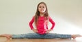 Little girl sits on a splits Royalty Free Stock Photo