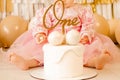 A little girl sits at the table and eats on her own. child holding a saucer with a cup Royalty Free Stock Photo